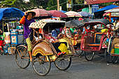 Riding the becak, the local cycle rickshaws in Malioboro street Yogyakarta.